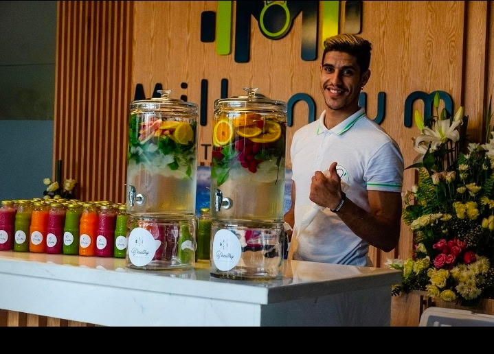 Fresh infused water and cold-pressed juice station at the wellness summit
