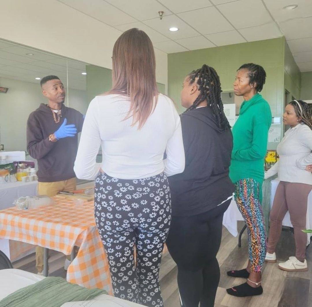 Marcus teaching a small wellness class around a fresh-food table